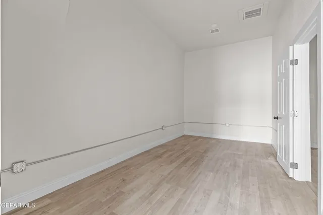 a view of a room with wooden floor