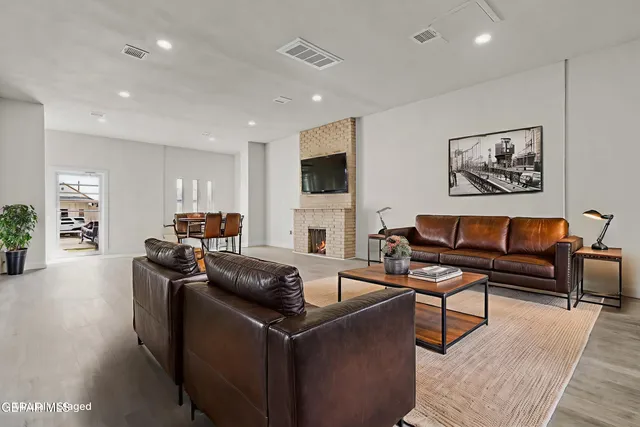 a living room with furniture a fireplace and a flat screen tv
