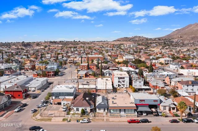an aerial view of residential houses with outdoor space