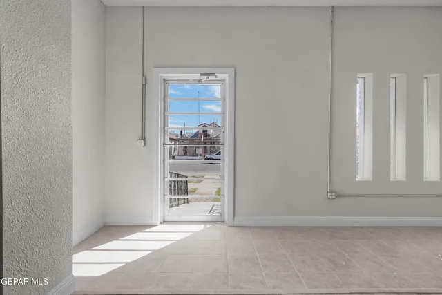 a view of an empty room with a cabinet