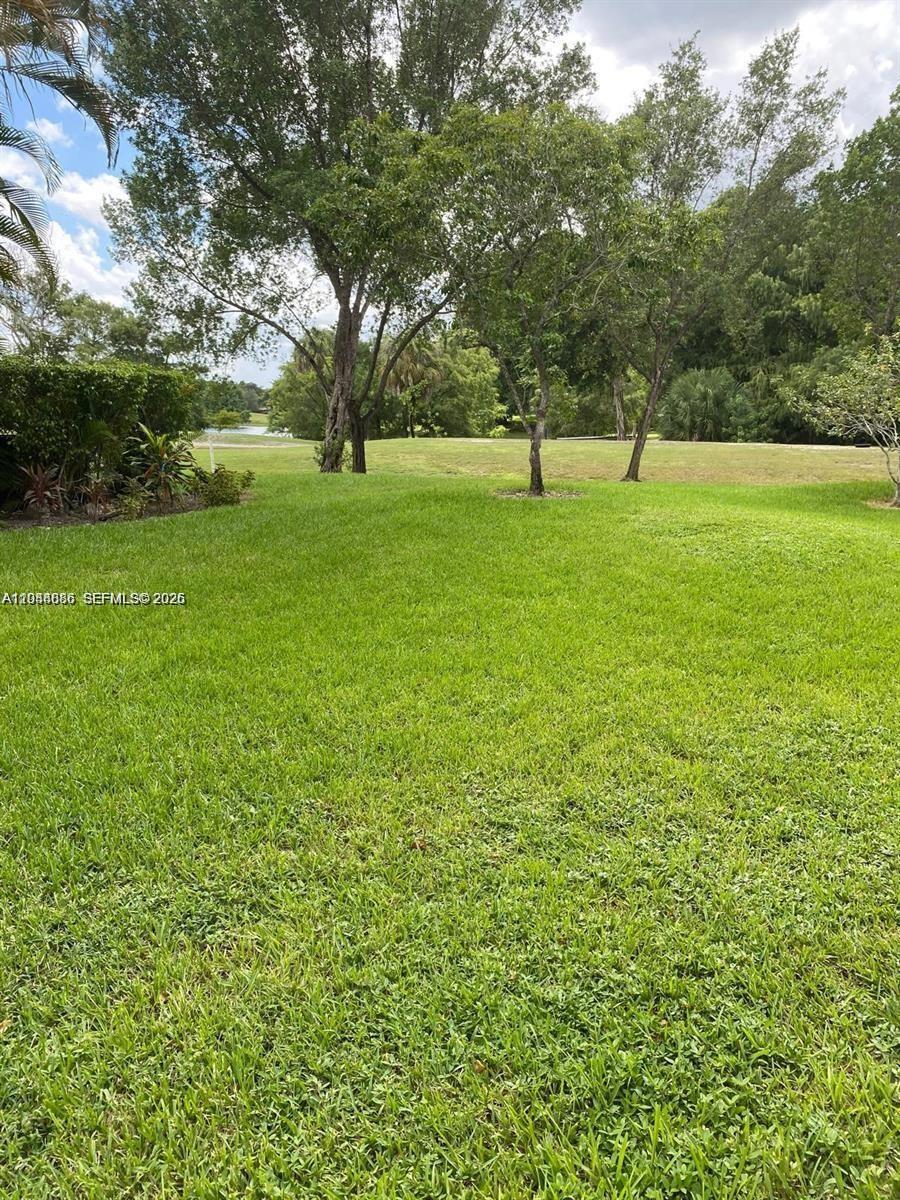 8838 West McNab Road, Unit 104 Tamarac, FL 33321 - Photo 22 of 23 a view of green field with trees in the background
