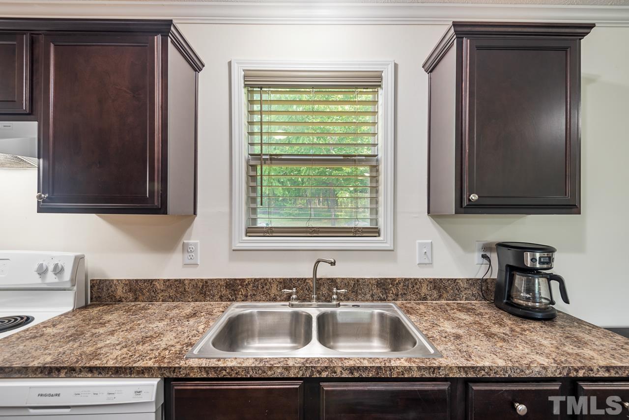 517 Circle B Farm Road Rougemont, NC 27572 - Photo 14 of 37 a kitchen with granite countertop a sink and a window