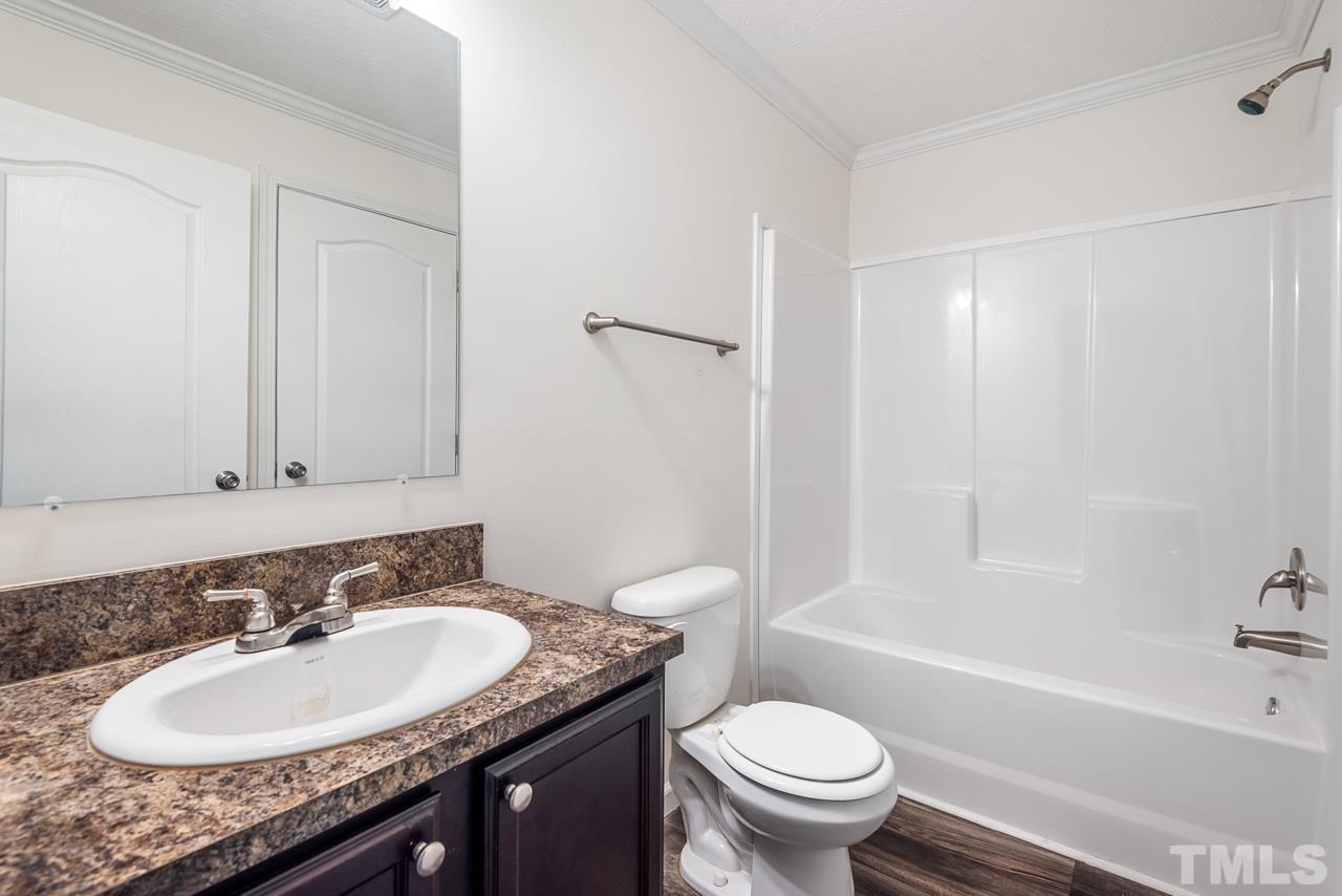 517 Circle B Farm Road Rougemont, NC 27572 - Photo 23 of 37 a bathroom with a granite countertop sink toilet and shower