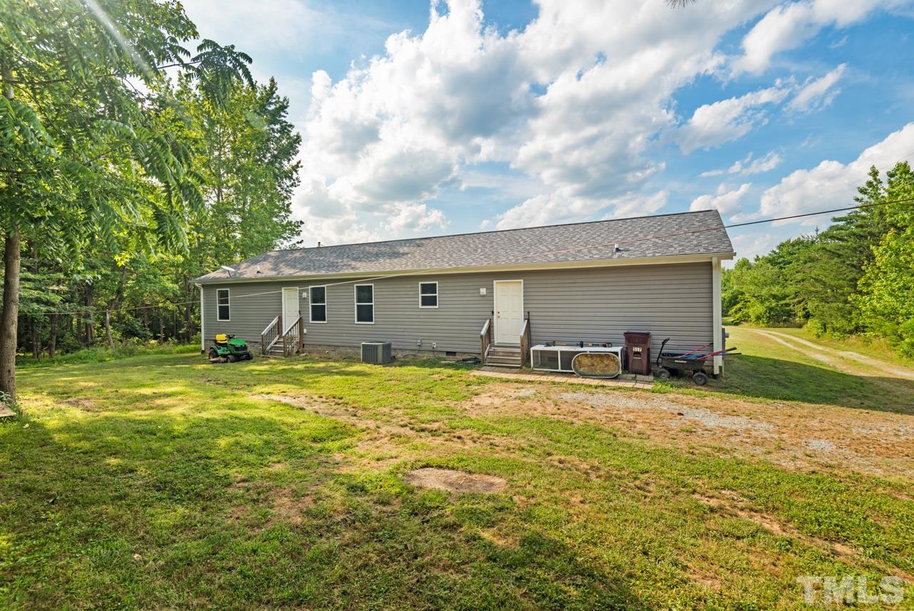 517 Circle B Farm Road Rougemont, NC 27572 - Photo 29 of 37 a view of a yard in front of a house with a large tree