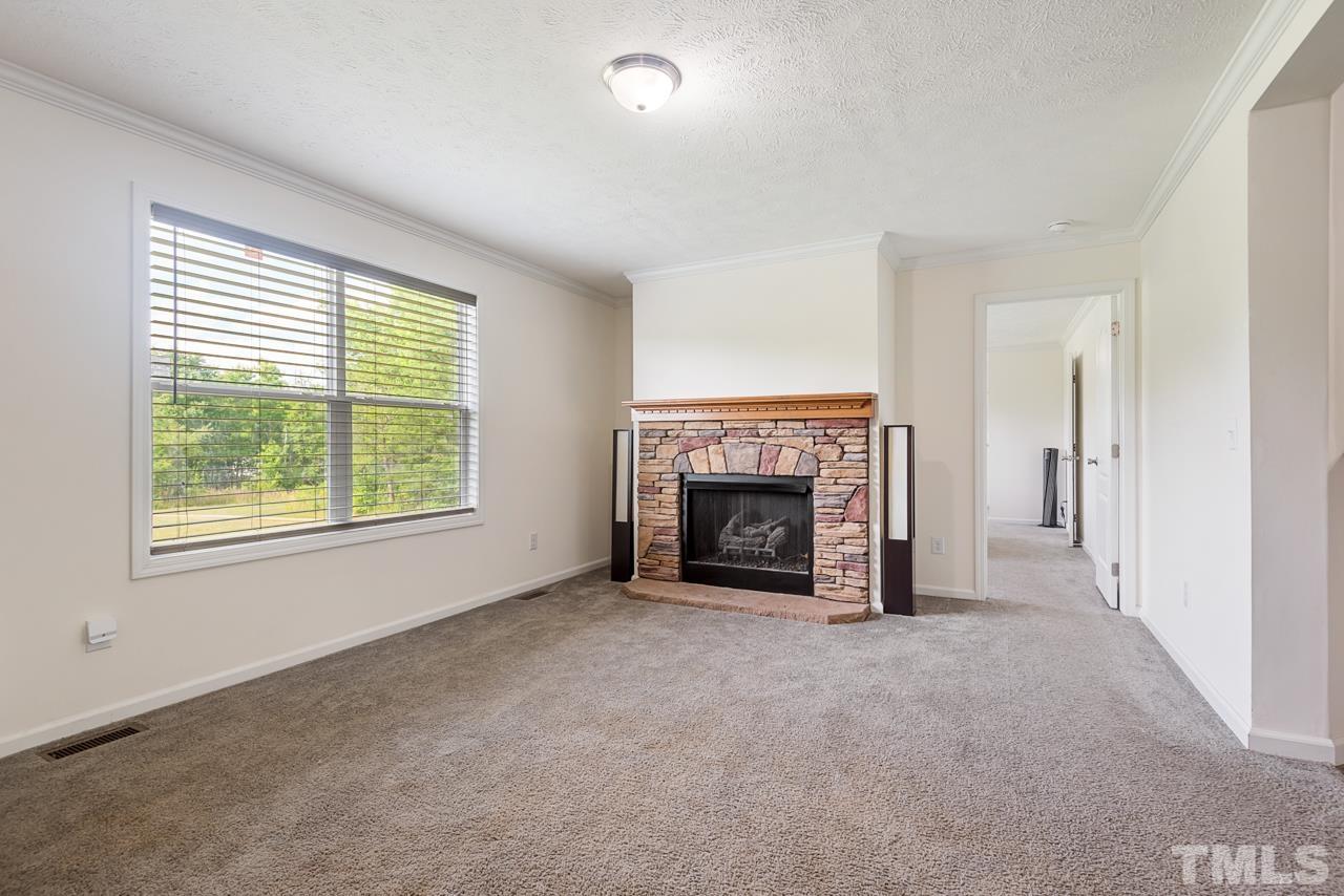 517 Circle B Farm Road Rougemont, NC 27572 - Photo 5 of 37 a view of an empty room with a window and fireplace