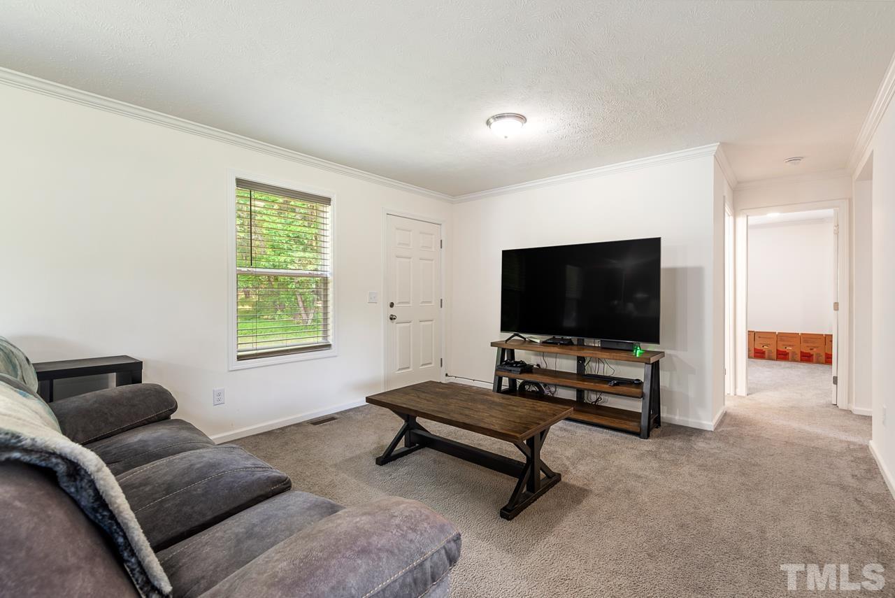 517 Circle B Farm Road Rougemont, NC 27572 - Photo 7 of 37 a living room with furniture and a flat screen tv