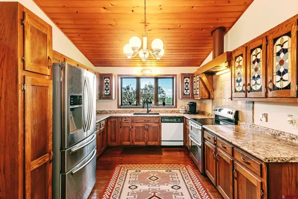 a kitchen with a stove a sink and a refrigerator