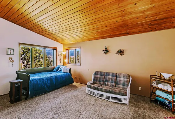a bedroom with furniture and a window