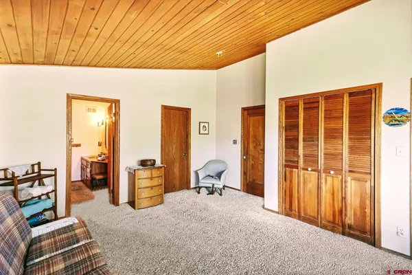 a bedroom with furniture and large window