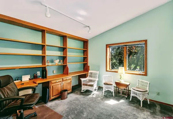 a room with a chair and a bookshelf