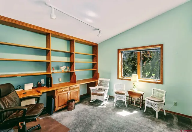 a room with a chair and a bookshelf