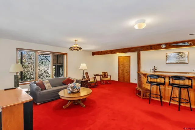 a living room with furniture and a dining table