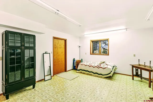 a spacious bedroom with a bed and window