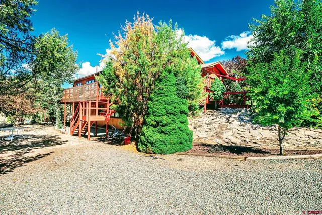 a view of a house with a yard and street
