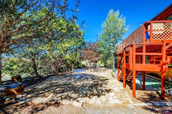 a backyard of a house with barbeque oven and outdoor seating