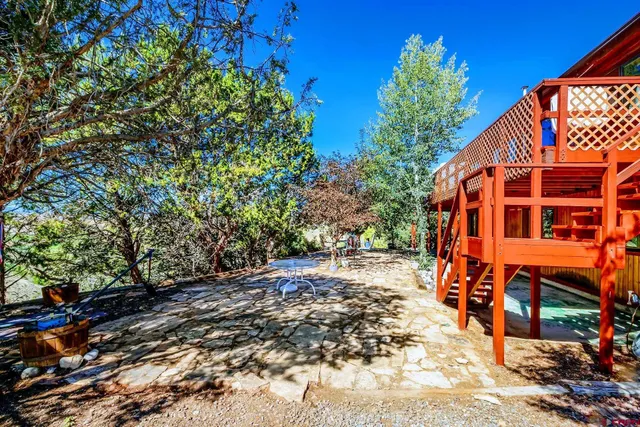 a backyard of a house with barbeque oven and outdoor seating