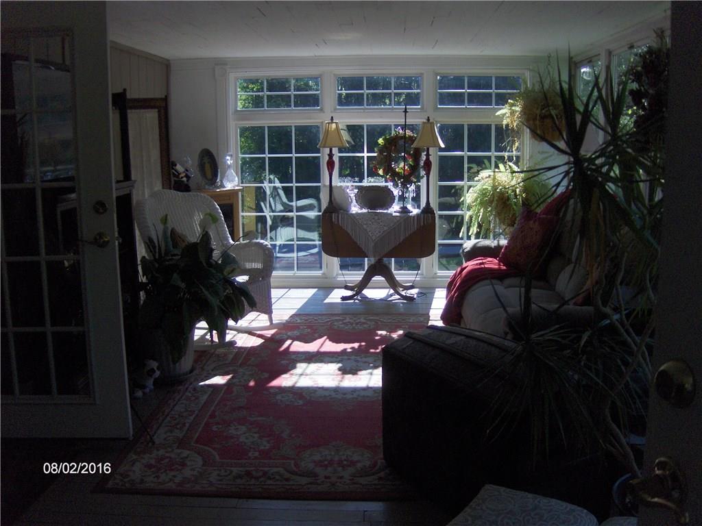 14 State Line Road Burgettstown, PA 15021 - Photo 3 of 18 Family room with lots of windows for natural light. Propane fireplace in the corner.