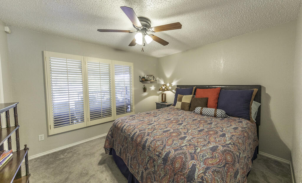 3620 93rd Street Lubbock, TX 79423 - Photo 24 of 33 a bedroom with a large bed and a large window