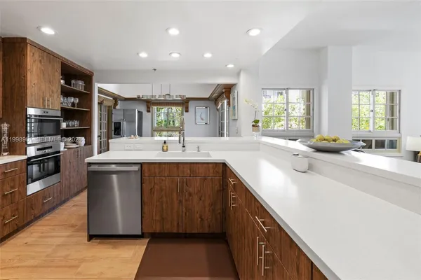 a dining room with furniture a chandelier and wooden floor
