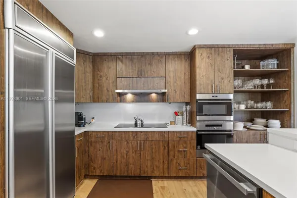 a living room with stainless steel appliances kitchen island granite countertop furniture and a dining table