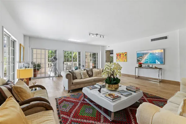 a bathroom with a granite countertop double vanity sink and a mirror