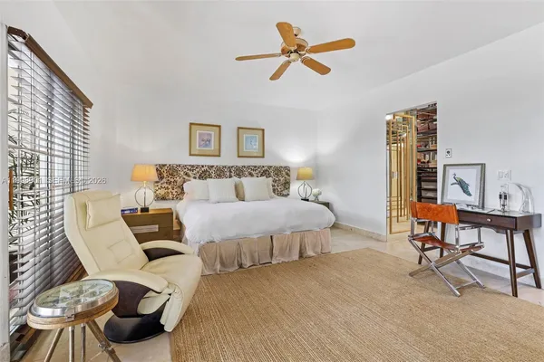 a bed room with a bed and a chair