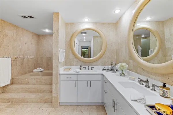 a bedroom with a balcony a bed and a chandelier