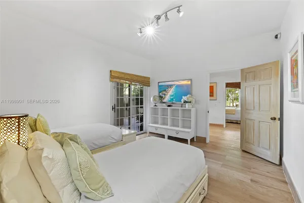 a front view of a building with garden and statue