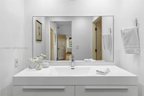 a front view of a multi story residential apartment building with yard and parking space