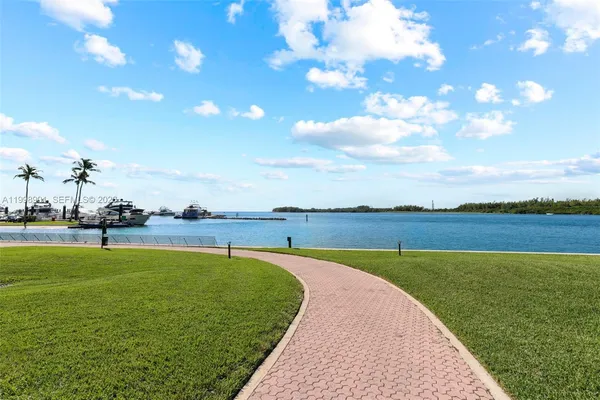 a view of a lake with a floor to ceiling window next to a building