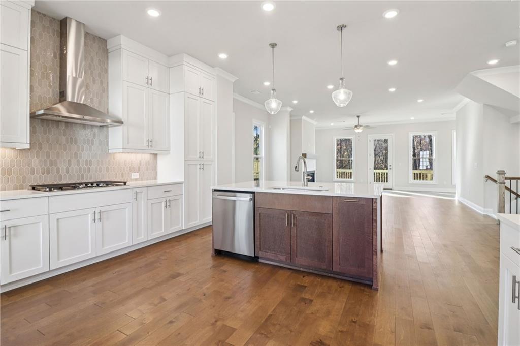159 Basil Street Cumming, GA 30040 - Photo 16 of 70 a large kitchen with kitchen island a sink stainless steel appliances and cabinets