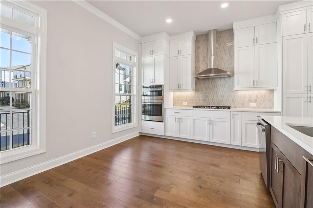 159 Basil Street Cumming, GA 30040 - Photo 17 of 70 a kitchen with stainless steel appliances granite countertop a stove a sink and a refrigerator