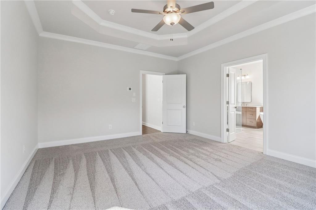 159 Basil Street Cumming, GA 30040 - Photo 23 of 70 a view of an empty room and chandelier fan