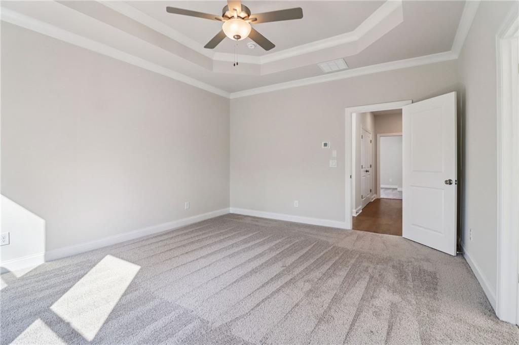 159 Basil Street Cumming, GA 30040 - Photo 24 of 70 a view of an empty room with a chandelier fan