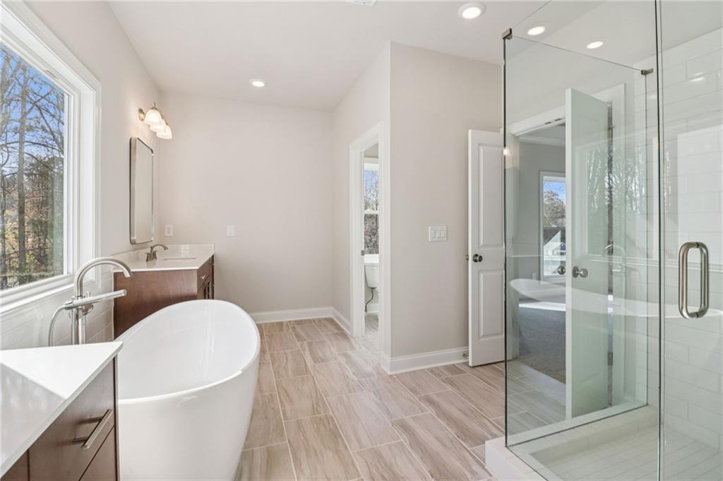 159 Basil Street Cumming, GA 30040 - Photo 26 of 70 a bathroom with a bathtub shower sink and toilet