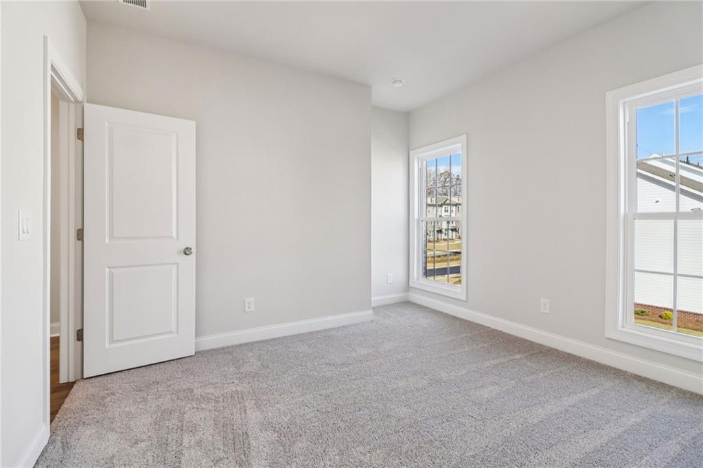 159 Basil Street Cumming, GA 30040 - Photo 34 of 70 a view of an empty room with windows