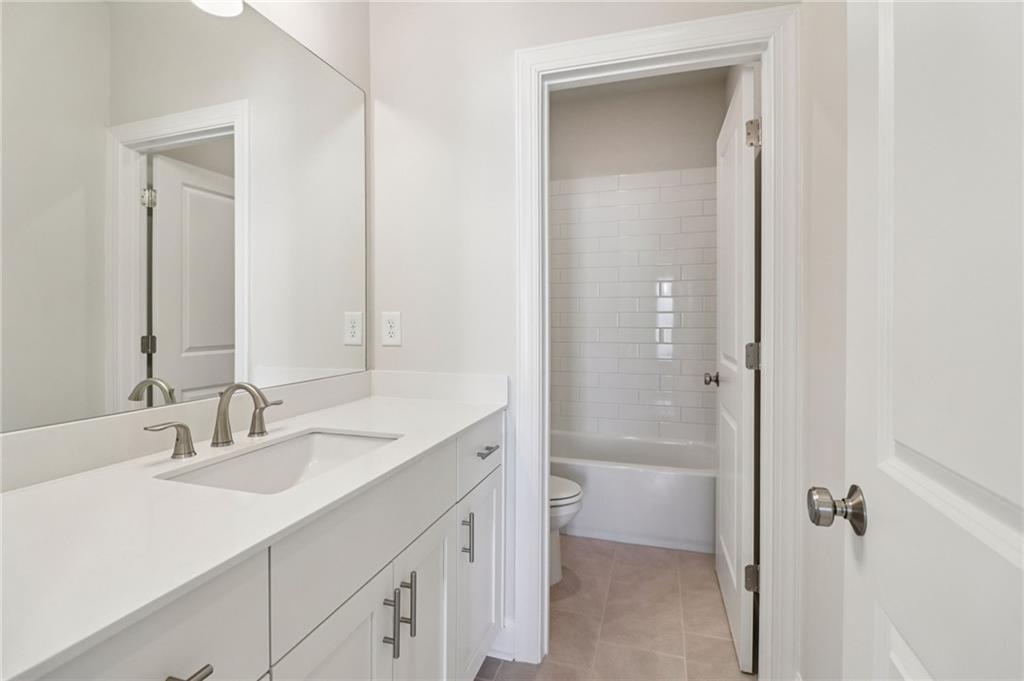 159 Basil Street Cumming, GA 30040 - Photo 37 of 70 a bathroom with a sink a toilet and shower
