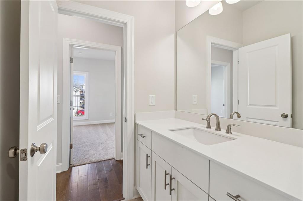 159 Basil Street Cumming, GA 30040 - Photo 39 of 70 a bathroom with a sink and a mirror