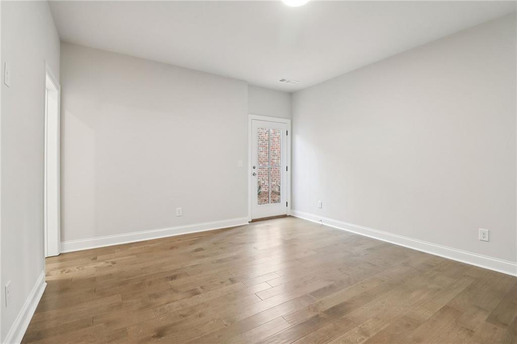 159 Basil Street Cumming, GA 30040 - Photo 43 of 70 a view of an empty room and wooden floor