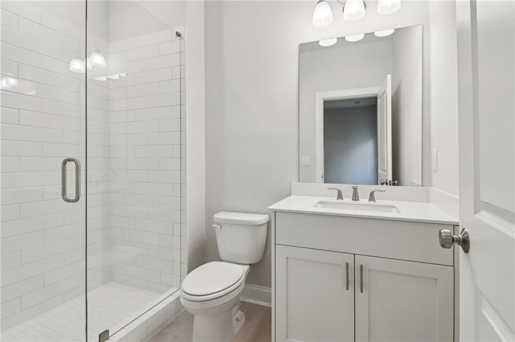 159 Basil Street Cumming, GA 30040 - Photo 44 of 70 a bathroom with a sink a toilet and shower