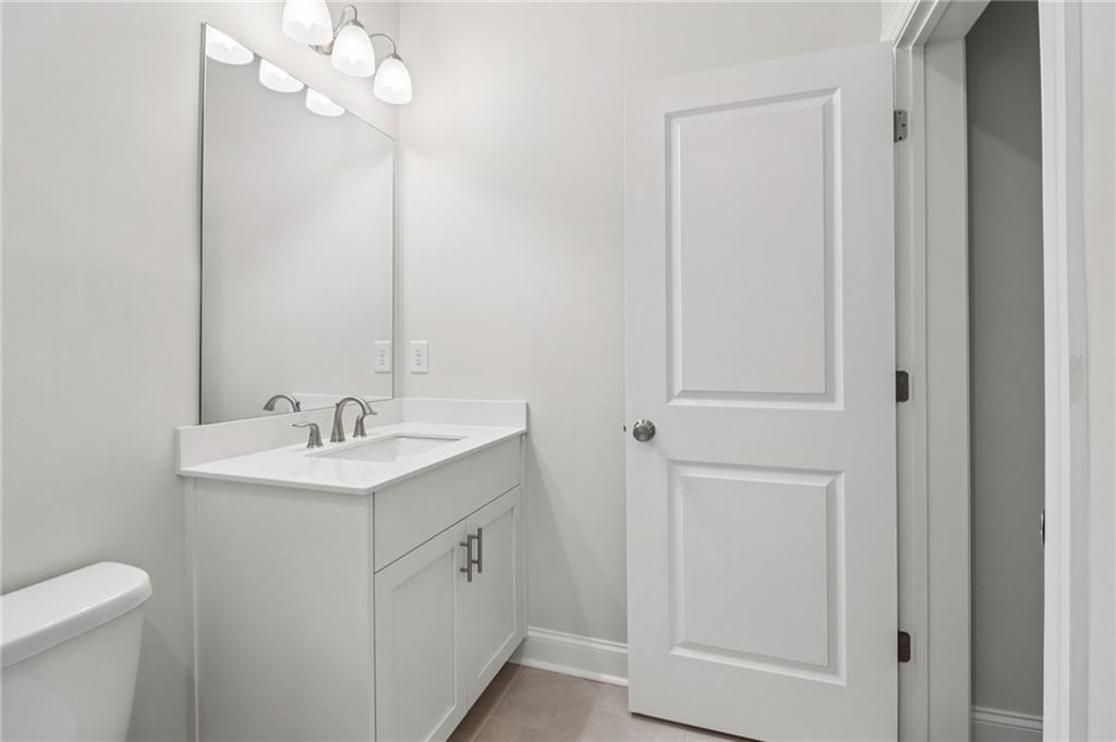 159 Basil Street Cumming, GA 30040 - Photo 45 of 70 a bathroom with a sink a toilet and a mirror