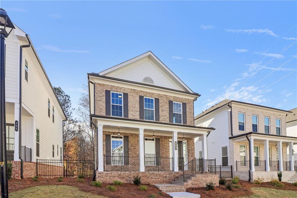 159 Basil Street Cumming, GA 30040 - Photo 5 of 70 a front view of a residential apartment building with a yard