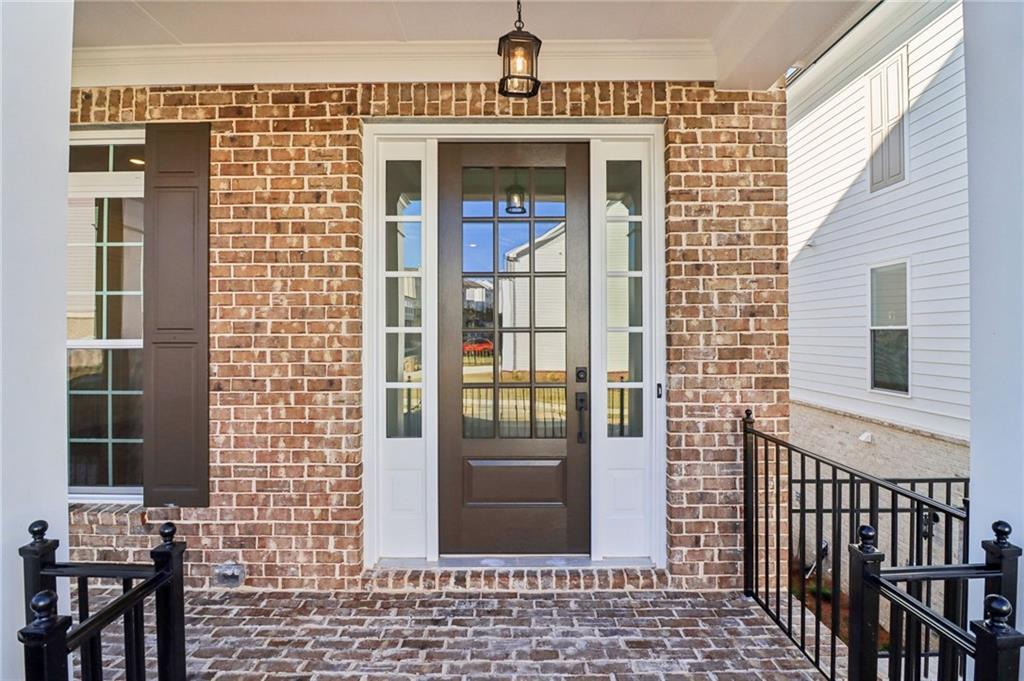 159 Basil Street Cumming, GA 30040 - Photo 6 of 70 a view of a brick house with large windows