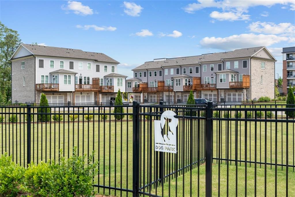 159 Basil Street Cumming, GA 30040 - Photo 62 of 70 a view of a brick house with many windows