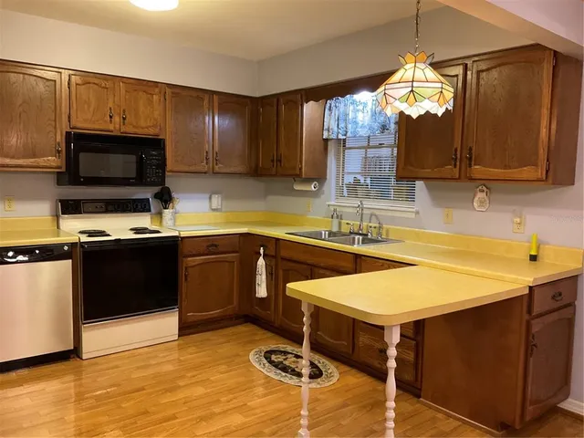 a kitchen with a sink appliances and cabinets