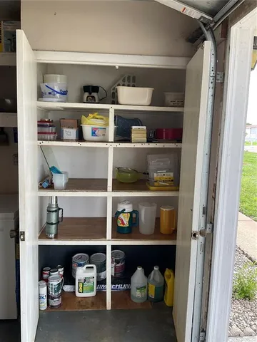 a shelf with cup and plates