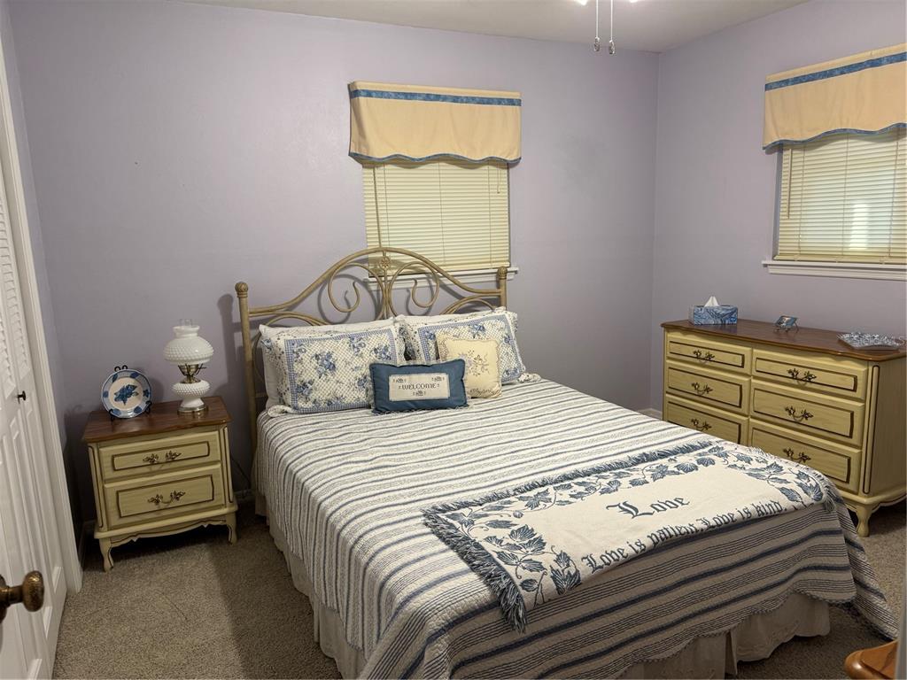 2438 Southeast 32nd Street Okeechobee, FL 34974 - Photo 27 of 42 a bedroom with a bed and a dresser