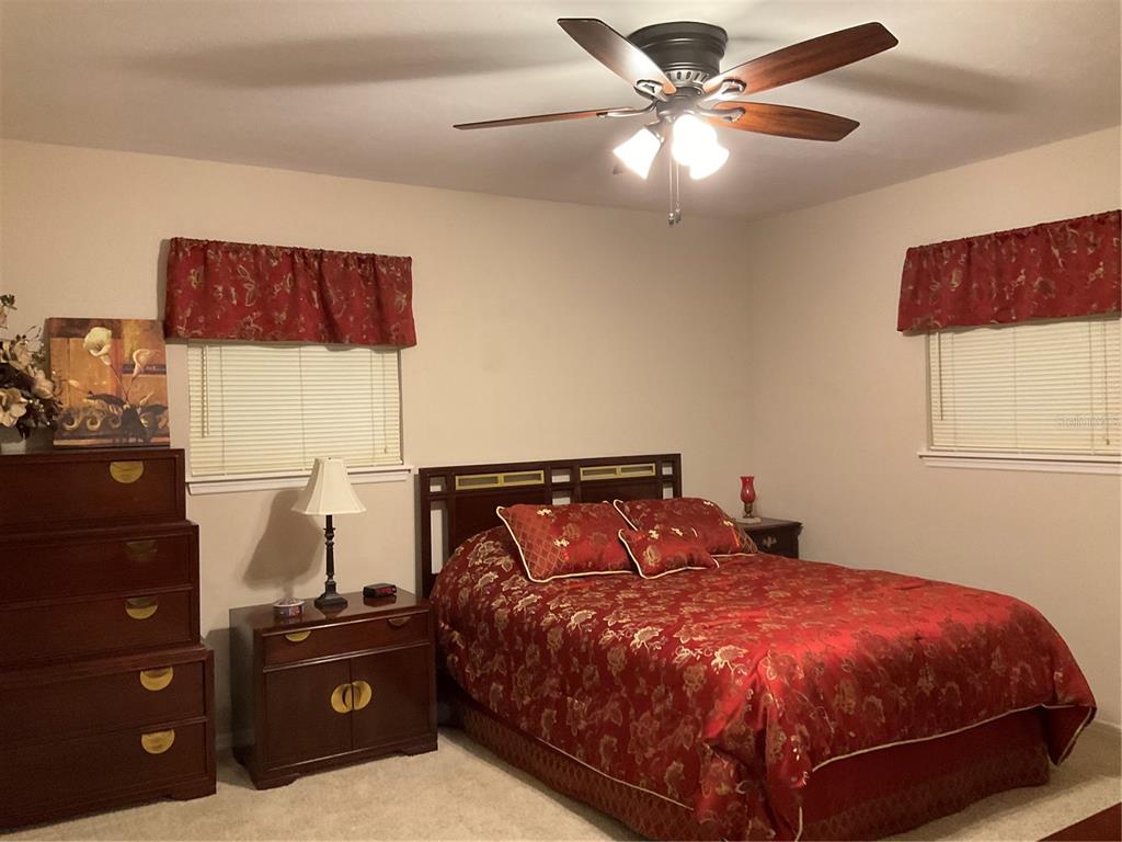 2438 Southeast 32nd Street Okeechobee, FL 34974 - Photo 3 of 42 a bedroom with a bed and a chandelier