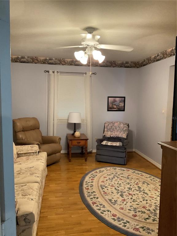 2438 Southeast 32nd Street Okeechobee, FL 34974 - Photo 36 of 42 a living room with furniture and a chandelier