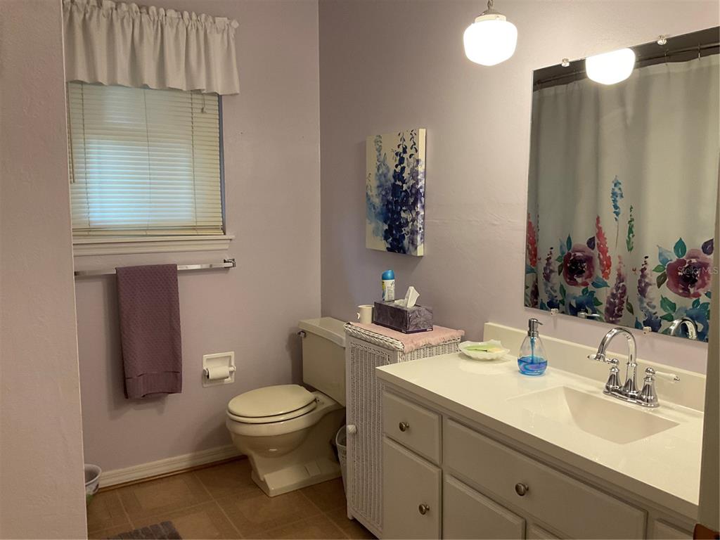 2438 Southeast 32nd Street Okeechobee, FL 34974 - Photo 38 of 42 a bathroom with a toilet a sink and mirror